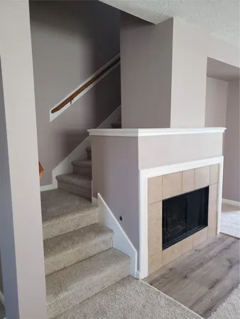 an empty room with windows and ceiling fan