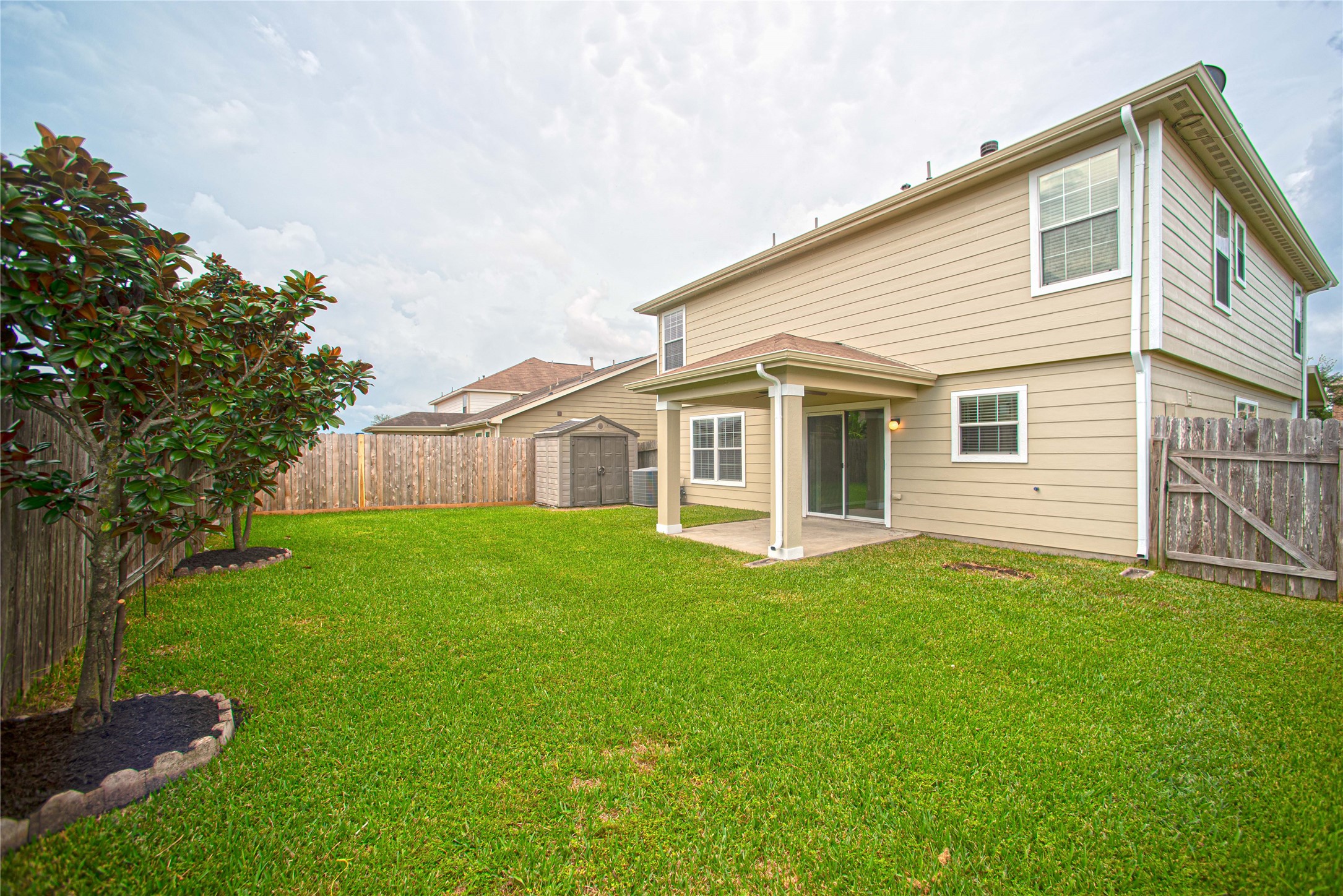 29314 Legends Bluff Drive Spring, TX 77386 - Photo 25 of 26 a view of a house with backyard and garden