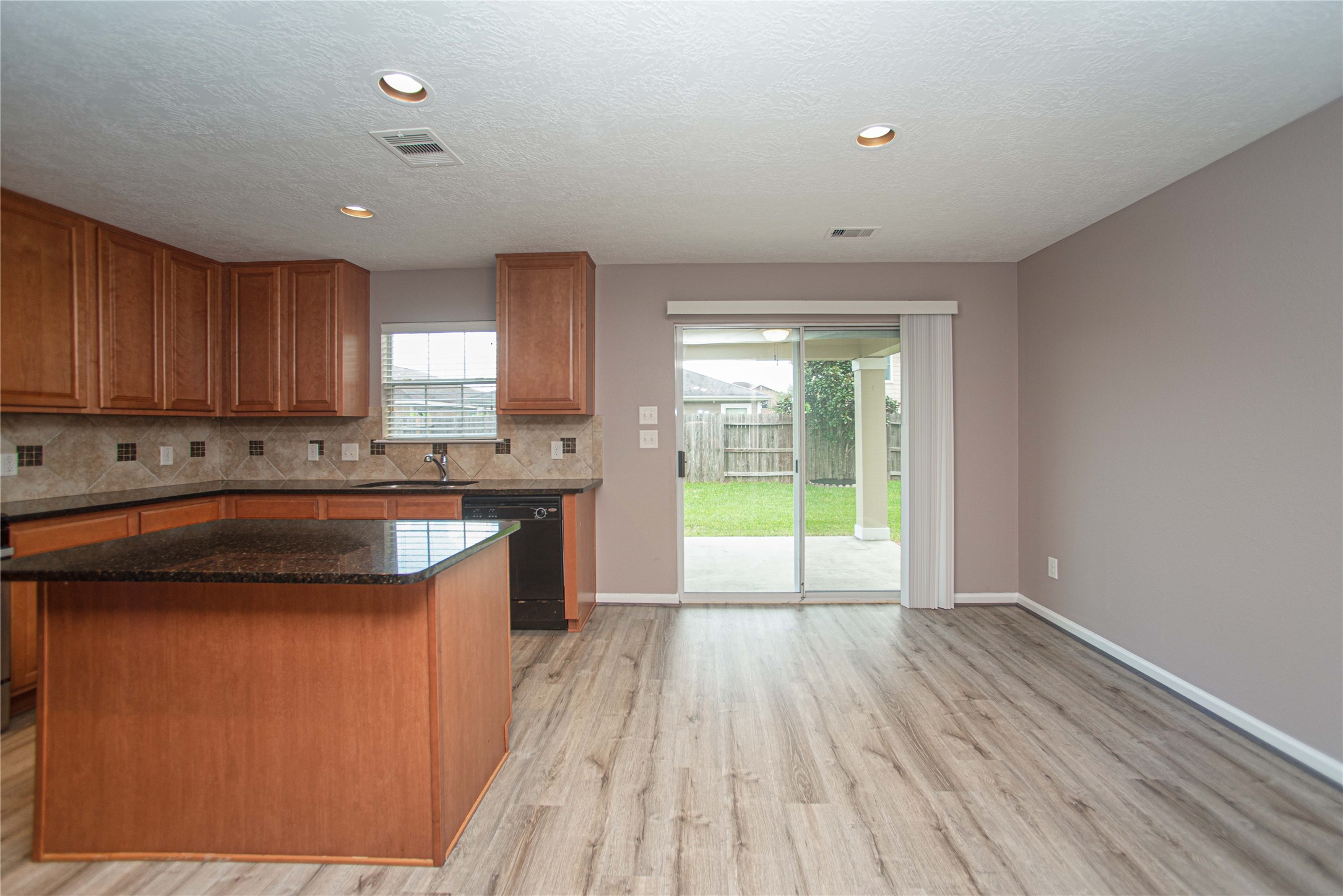 29314 Legends Bluff Drive Spring, TX 77386 - Photo 8 of 26 a kitchen with granite countertop a stove a sink and a microwave