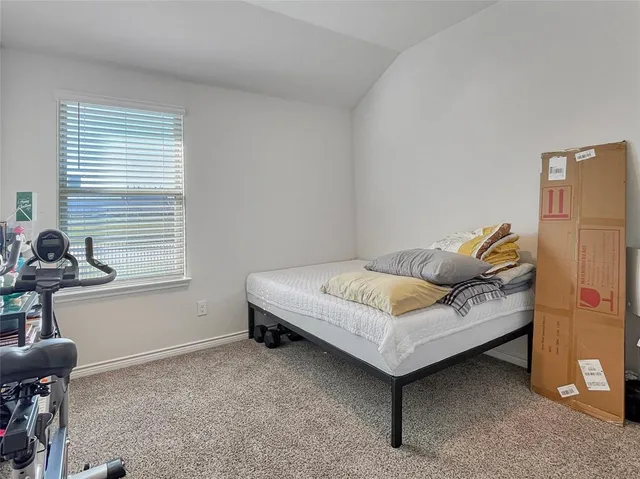 a bedroom with a bed and a table