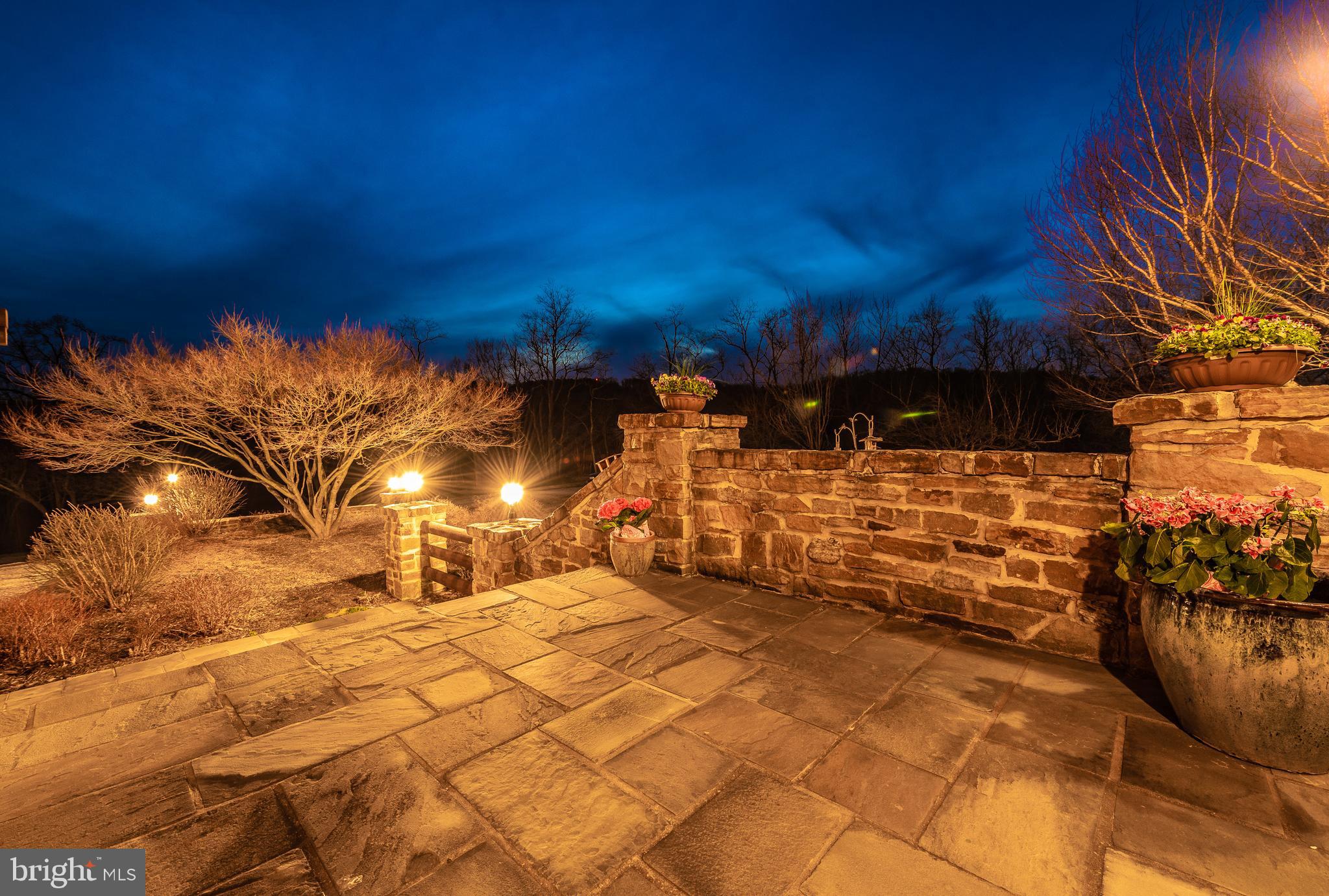 Stone patio and steps lead to front entrance