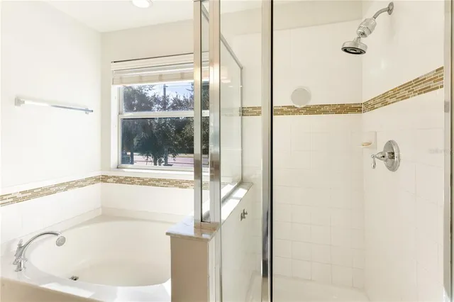 a view of a workspace room with furniture and a window