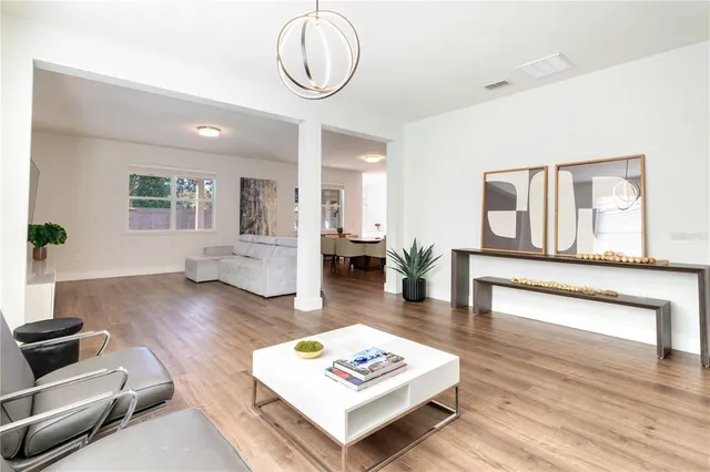 a dining room with furniture and wooden floor