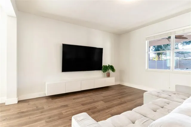 a room with stainless steel appliances kitchen island granite countertop a sink and cabinets