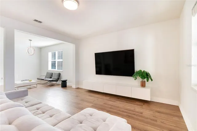 a dining room with furniture and wooden floor