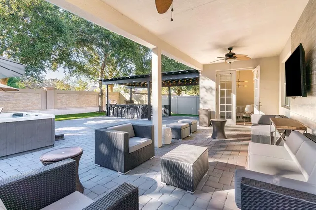 a view of a patio with table and chairs under an umbrella