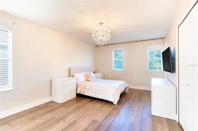 a bedroom with a bed and a chandelier