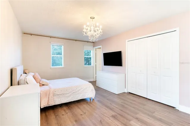 a bedroom with a bed and a flat screen tv