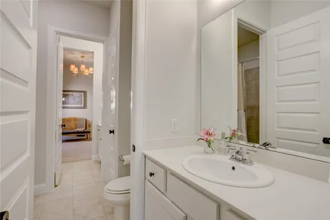 a bathroom with a sink and a mirror with toilet