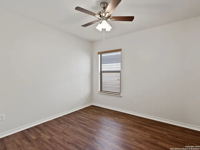 a view of a room with wooden floor