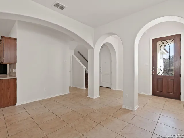 a kitchen with stainless steel appliances granite countertop a sink stove a refrigerator and a microwave