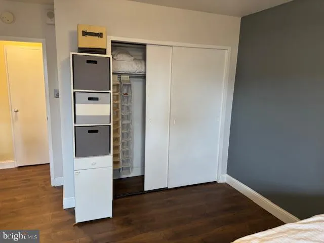 a view of walk in closet with wooden floor