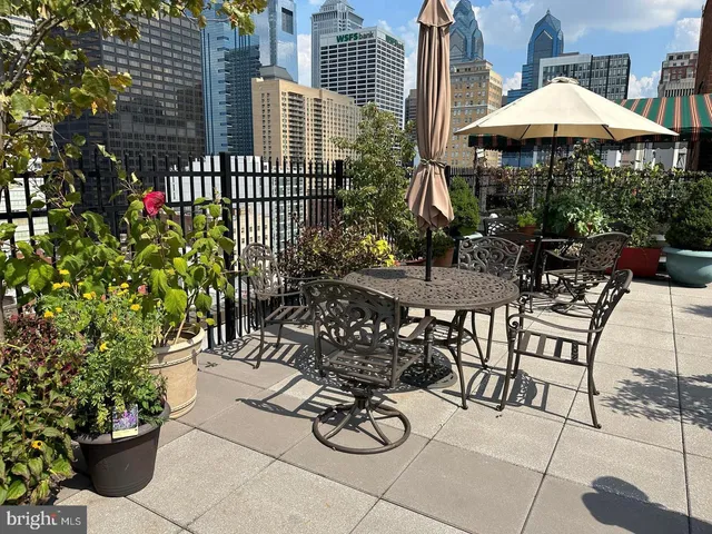 a view of a chairs and table in backyard