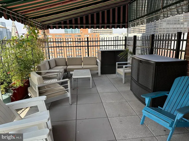 a view of a patio with a table and chairs and potted plants