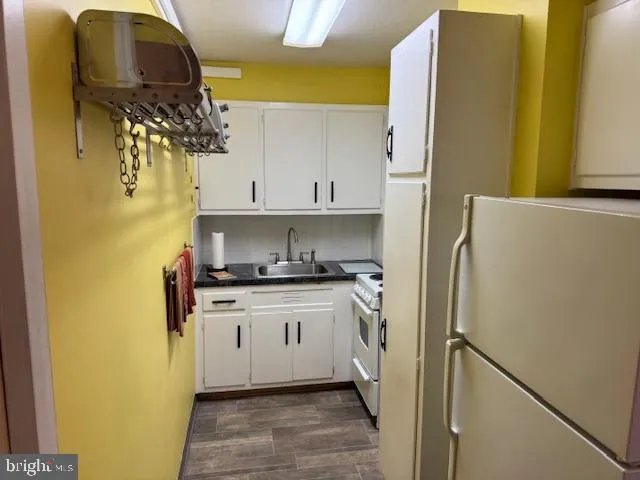 a kitchen with a white stove top oven and sink