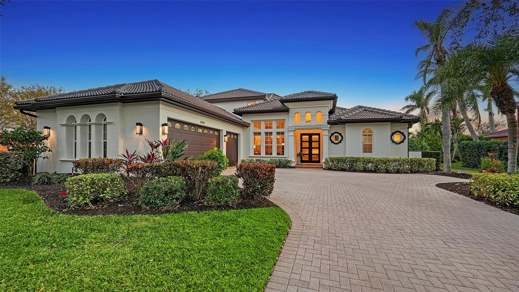 a front view of a house with a garden