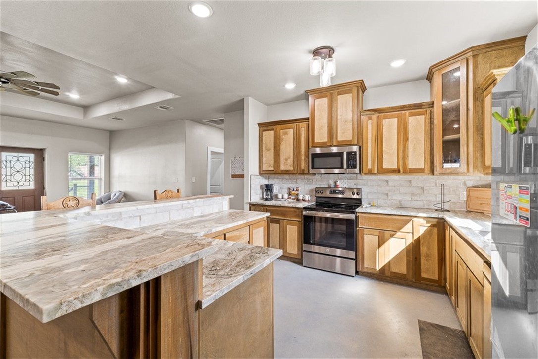 207 South Charles Street George West, TX 78022 - Photo 12 of 24 a large kitchen with granite countertop lots of counter top space