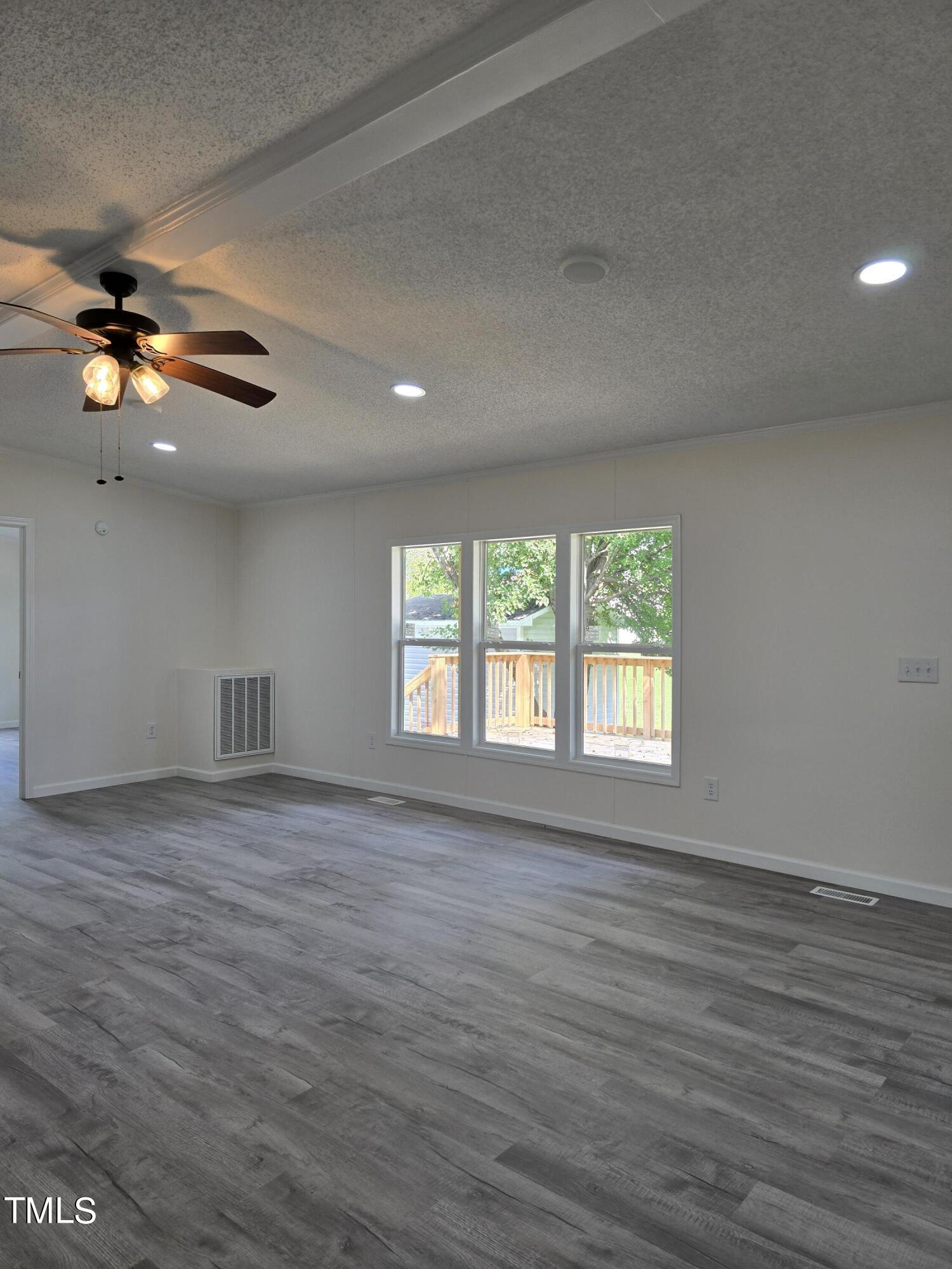 1096 Worthville Road Randleman, NC 27317 - Photo 11 of 20 a view of an empty room with a window and wooden floor