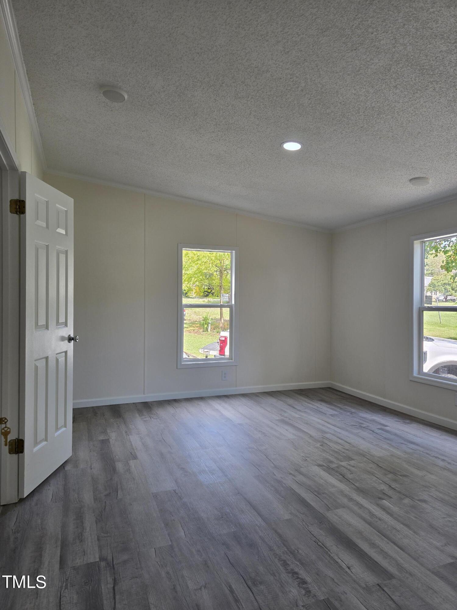 1096 Worthville Road Randleman, NC 27317 - Photo 12 of 20 an empty room with wooden floor and windows