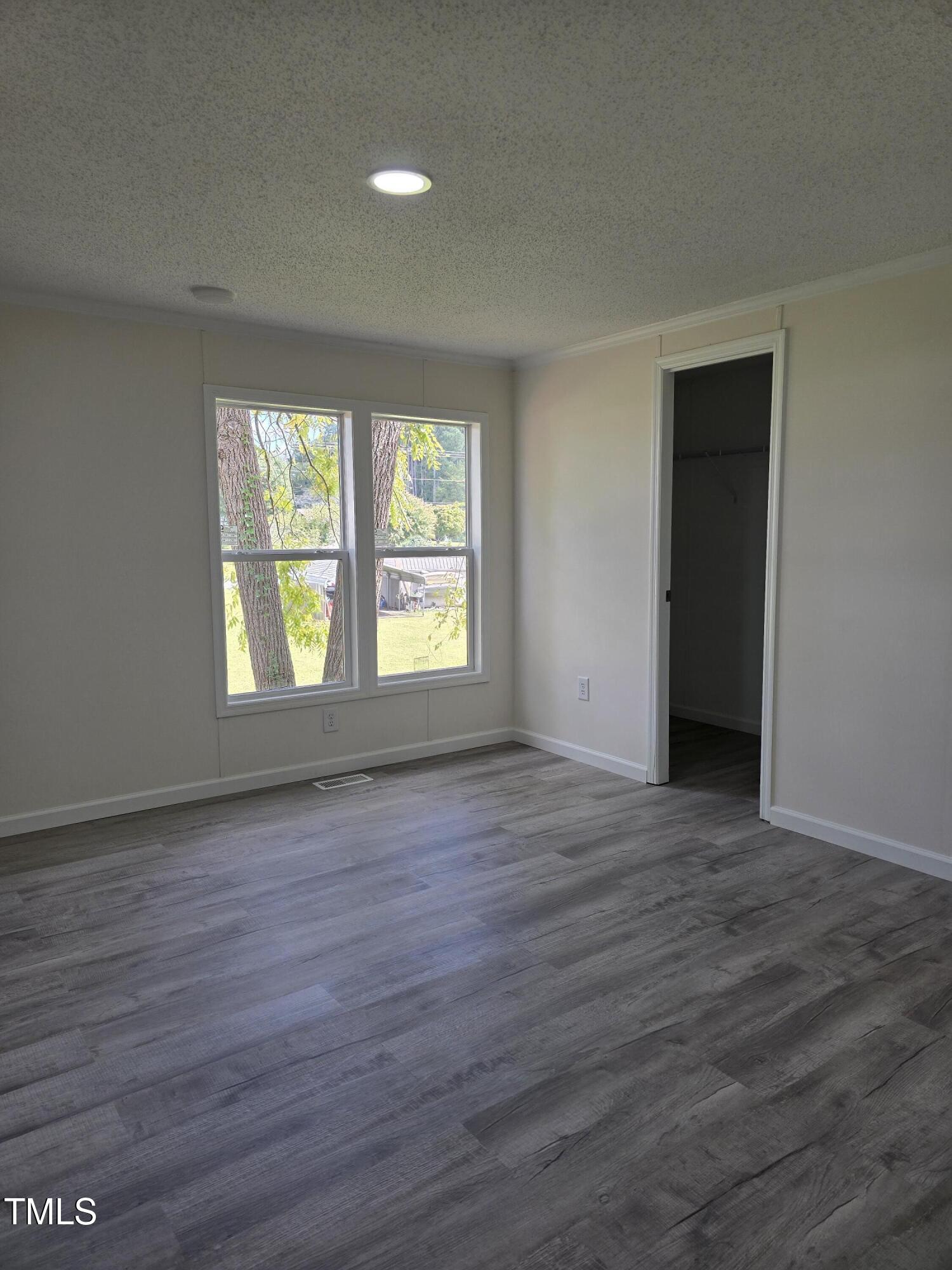 1096 Worthville Road Randleman, NC 27317 - Photo 15 of 20 an empty room with wooden floor and windows