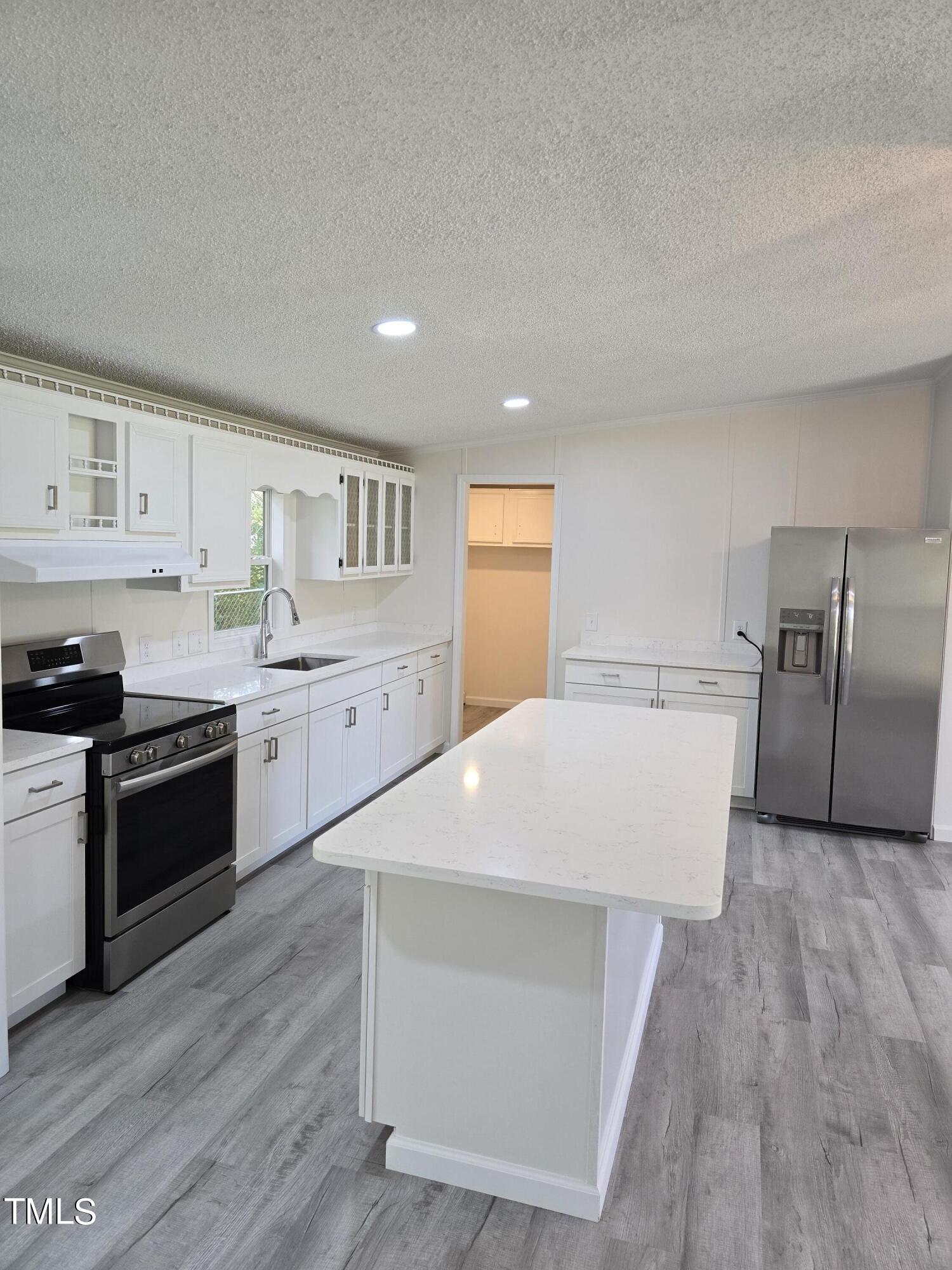 1096 Worthville Road Randleman, NC 27317 - Photo 6 of 20 a kitchen with stainless steel appliances a refrigerator sink and stove