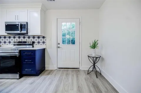 a kitchen with a sink and a stove top oven