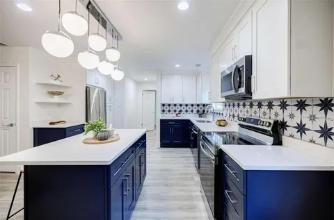 a kitchen with a sink stove and cabinets