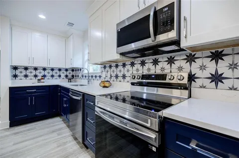 a kitchen with a sink cabinets and window