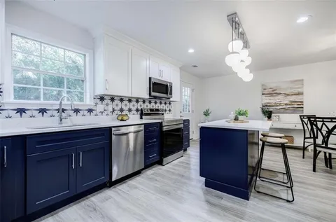 a view of a kitchen counter top and a table chair