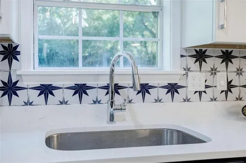 a large kitchen with a table and chairs