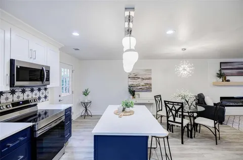 a kitchen with a table and chairs in it