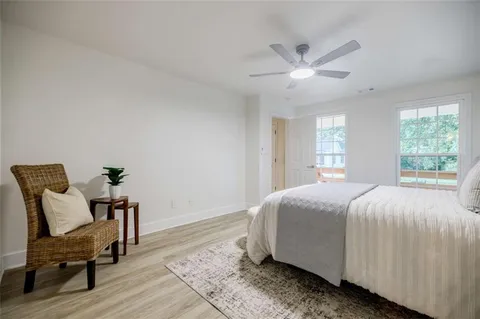 a bedroom with a bed and a ceiling fan