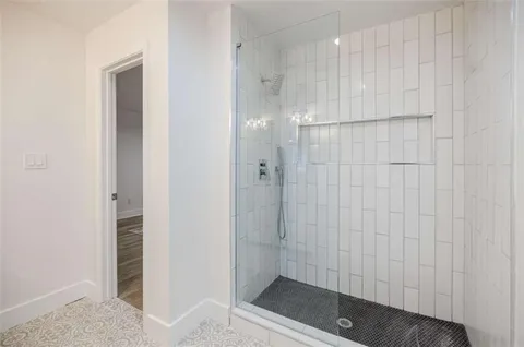 a bathroom with a shower and a sink
