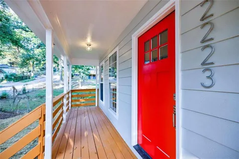 a view of balcony with wooden floor and fence
