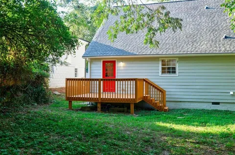 a view of house with outdoor seating area