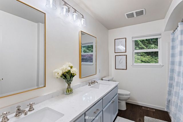a bathroom with a sink toilet and a mirror