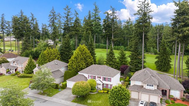 an aerial view of multiple houses with yard