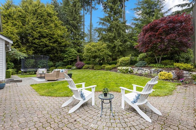 a white house with a yard and sitting area