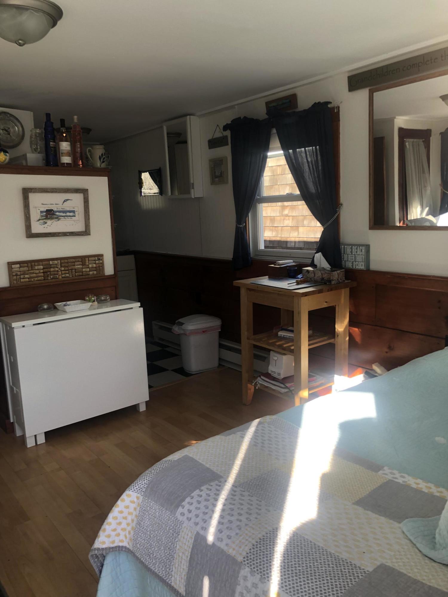 17 Shore Road, Unit 7 Truro, MA 02666 - Photo 11 of 11 a living room with furniture a window and a fireplace