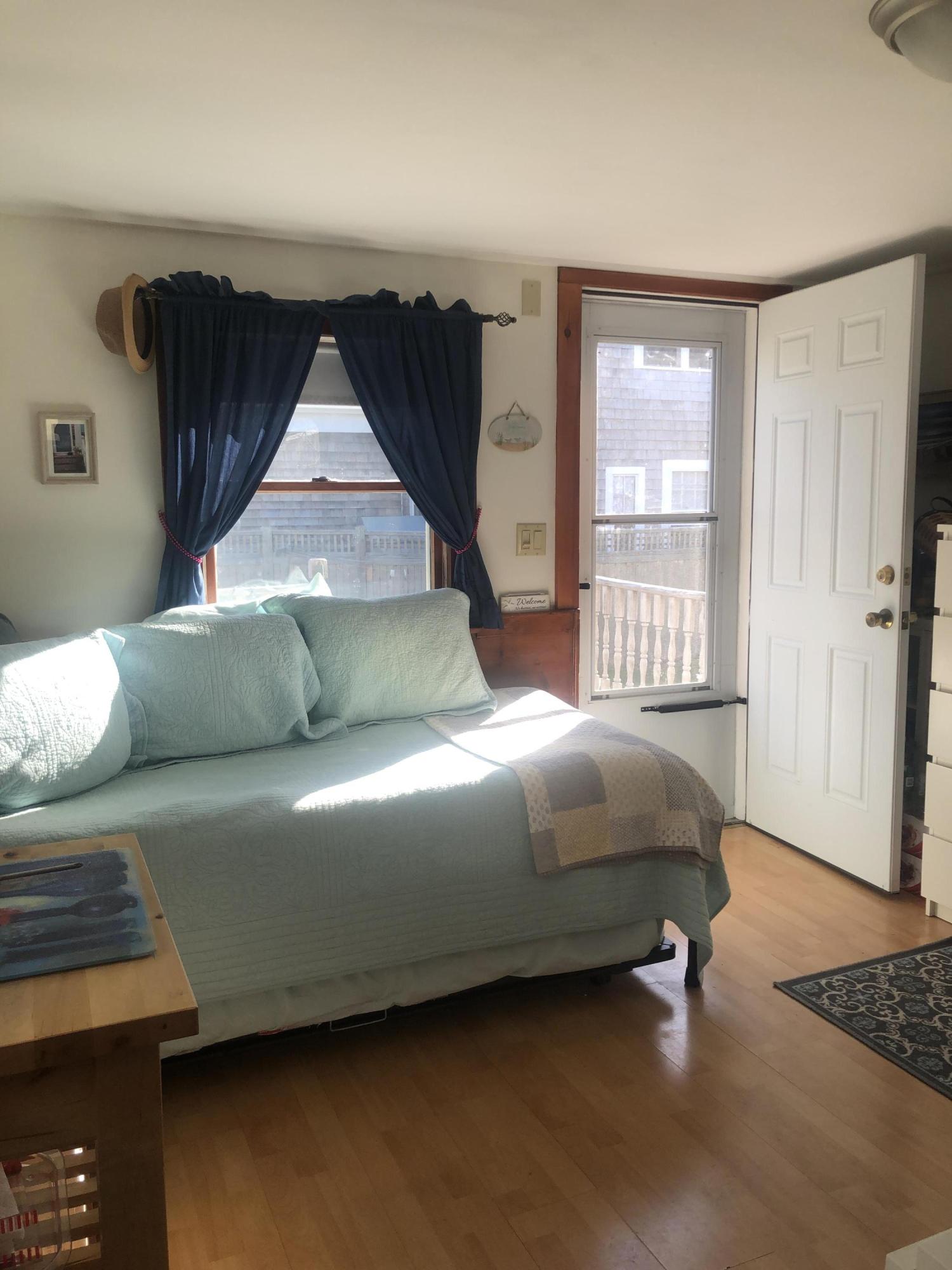 17 Shore Road, Unit 7 Truro, MA 02666 - Photo 7 of 11 a bedroom with a bed and window