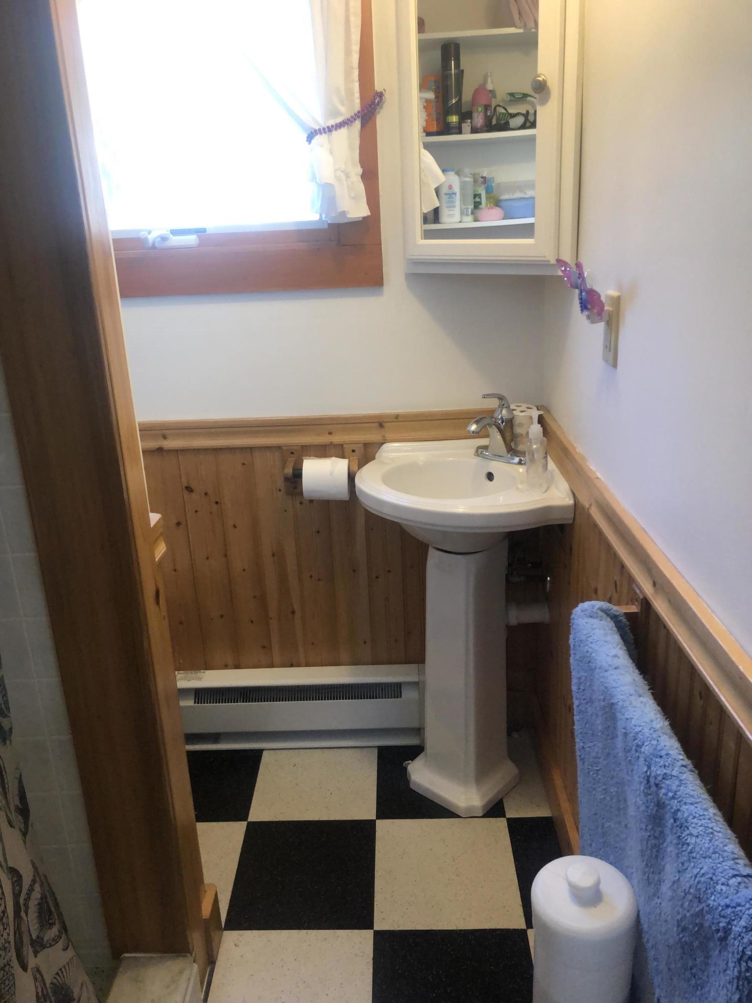 17 Shore Road, Unit 7 Truro, MA 02666 - Photo 9 of 11 a bathroom with a sink a toilet and a window