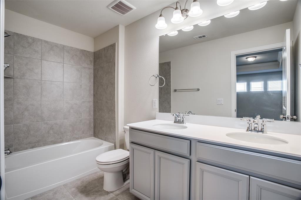 1237 Sharp Street Anna, TX 75409 - Photo 13 of 18 a bathroom with a sink a toilet and shower