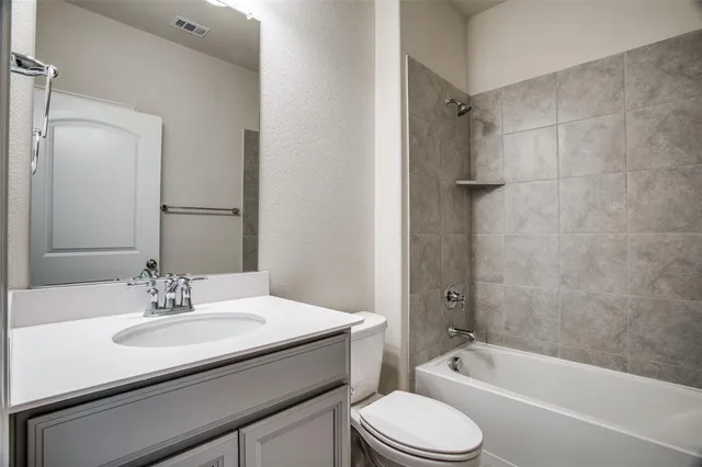 a bathroom with a sink toilet a bathtub and shower