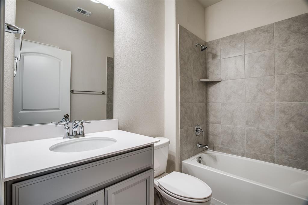 1237 Sharp Street Anna, TX 75409 - Photo 15 of 18 a bathroom with a sink toilet a bathtub and shower