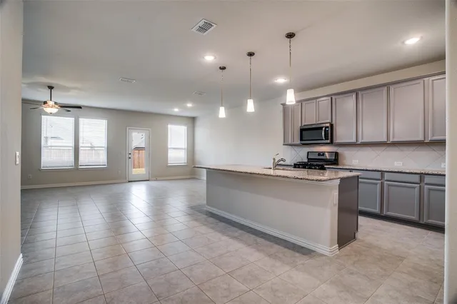 a view of a kitchen with a sink and microwave