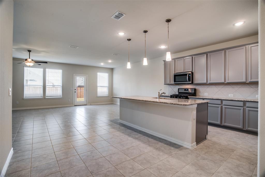 1237 Sharp Street Anna, TX 75409 - Photo 4 of 18 a view of a kitchen with a sink and microwave