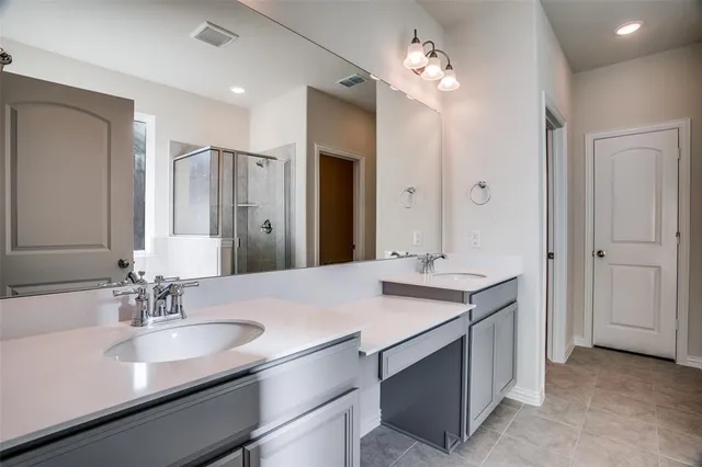 a bathroom with a sink double vanity and a mirror
