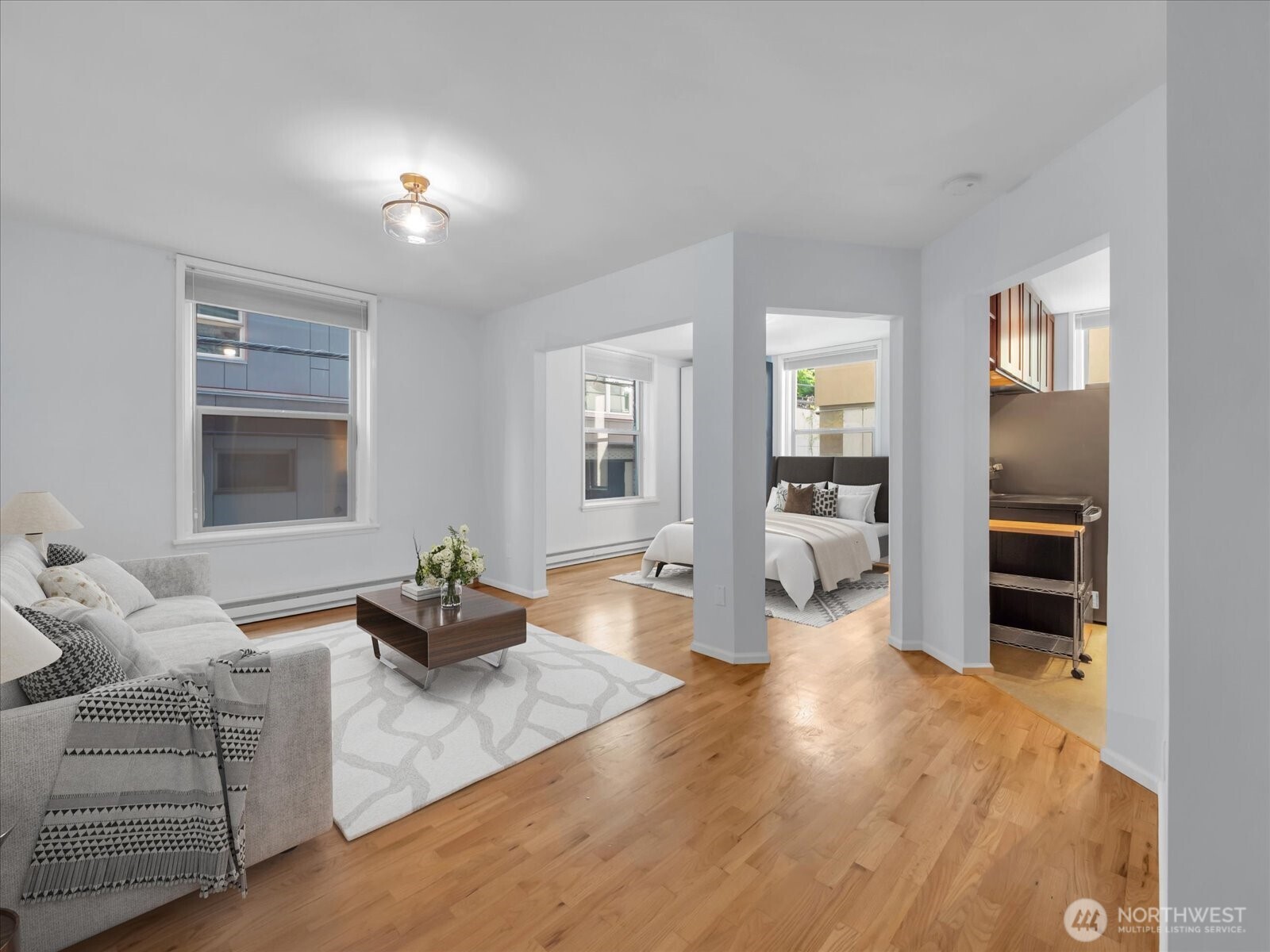 7 Harrison Street, Unit 17 Seattle, WA 98109 - Photo 5 of 20 a living room with furniture and wooden floor