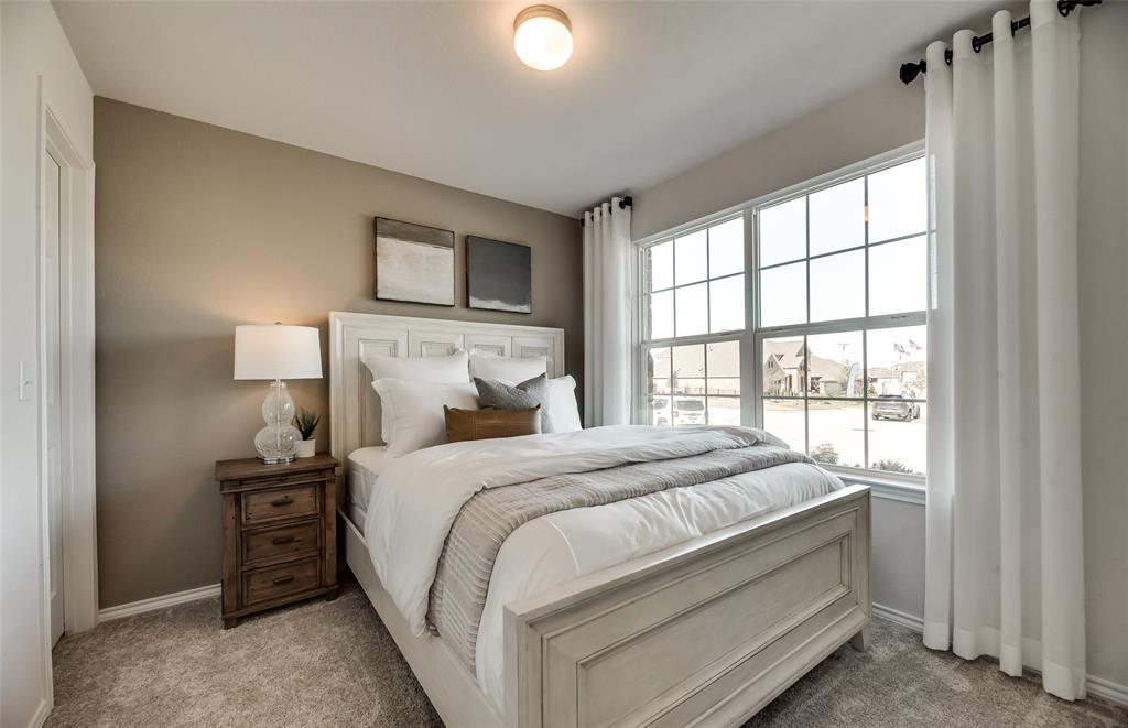 *Model Representation - Spacious secondary bedroom with large windows 
