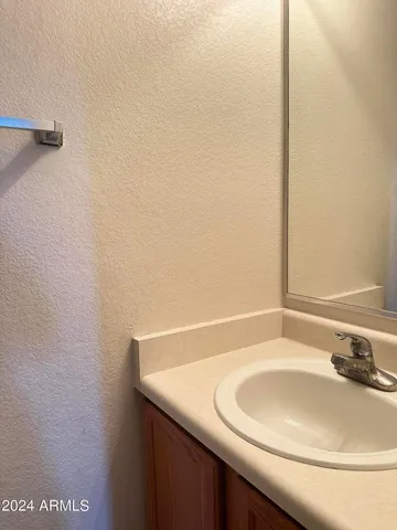 a bathroom with a sink and a white cabinet